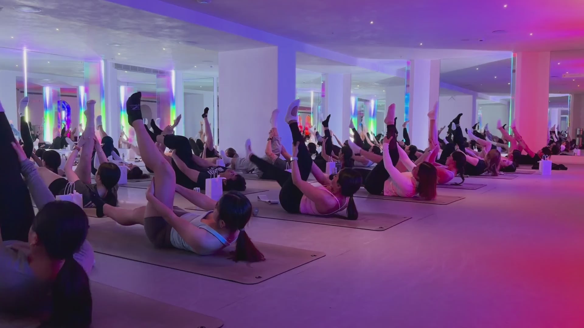 AusCorp Pilates for lunch at One Playground in Haymarket: the class mid-workout under coloured studio lights